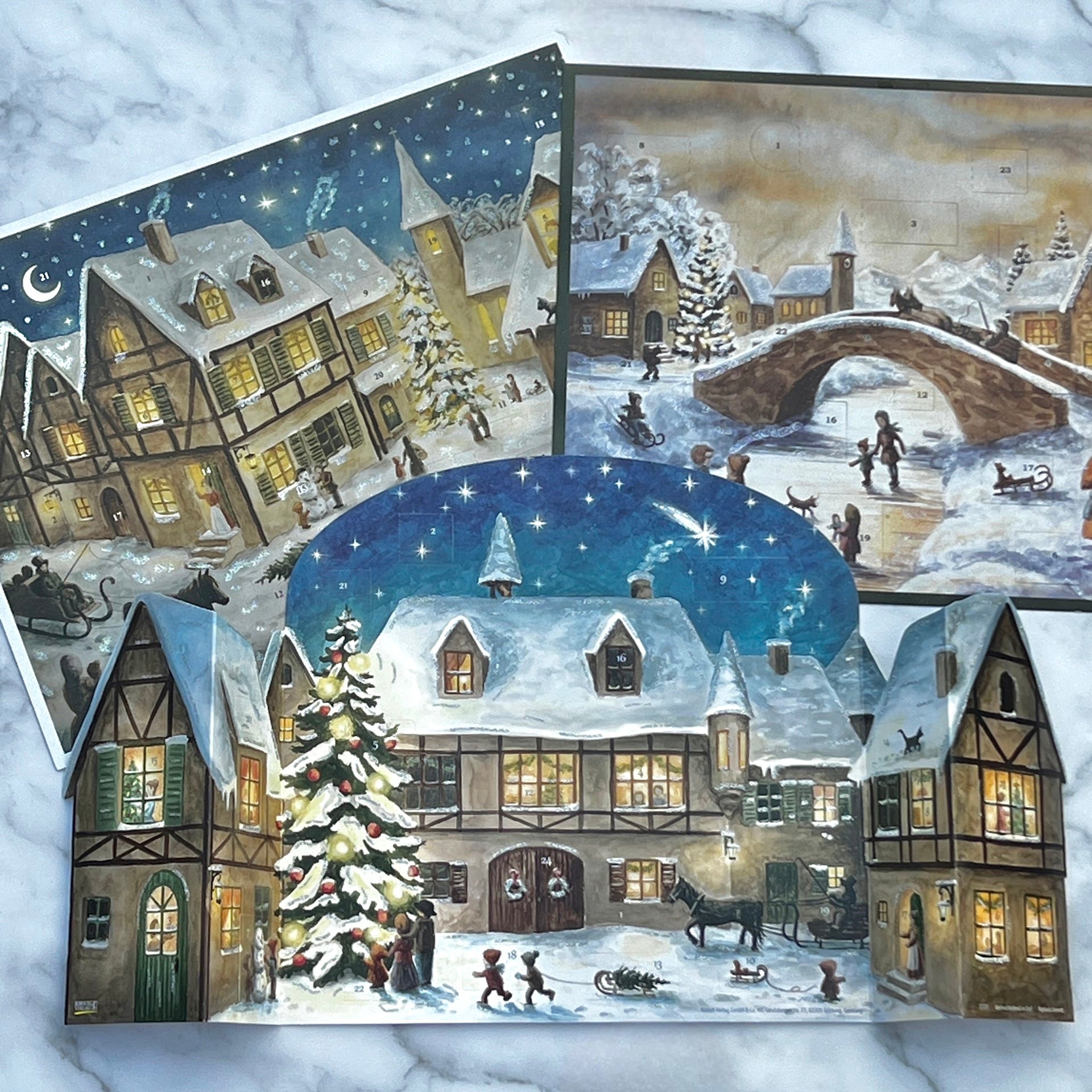 Adventskalender 3D snötäckt stad med korsvirkeshus